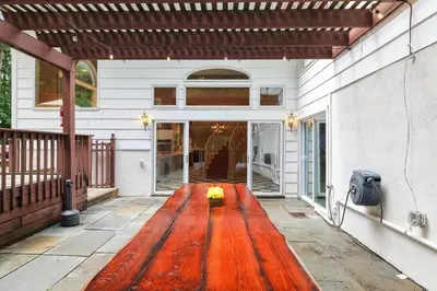 a porch with a wooden floor on a house at Luxury Villa with Year Round Heated Pool, Sauna, Spa & Fire Pit - Newly Redone in East Stroudsburg