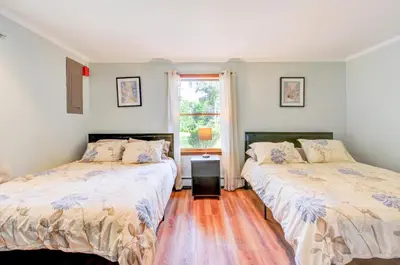 a bedroom with two beds and a window at Luxury Villa with Year Round Heated Pool, Sauna, Spa & Fire Pit - Newly Redone in East Stroudsburg