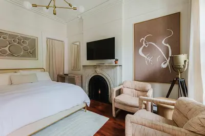 a bedroom with a bed and a tv and a fireplace at The West Village Gem in New York