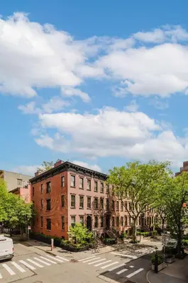 a building on a city street with a sky at The West Village Gem in New York