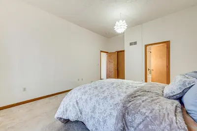 a bedroom with a bed in a white room at 11 Mi to Camelback Resort Tobyhanna Home! in Tobyhanna