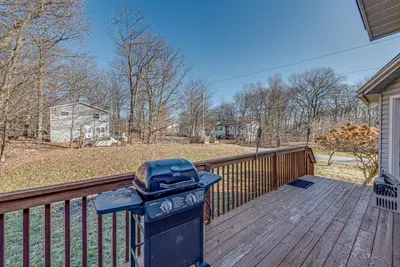 a grill sitting on a deck on a house at 11 Mi to Camelback Resort Tobyhanna Home! in Tobyhanna