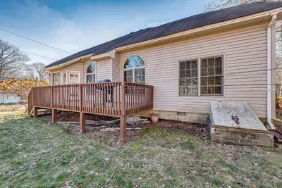a house with a wooden deck in front of it at 11 Mi to Camelback Resort Tobyhanna Home! in Tobyhanna