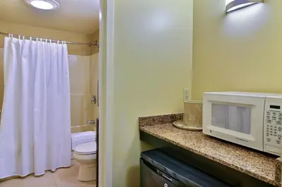 a bathroom with a toilet and a microwave at Pine Barn Inn in Danville