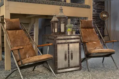 a couple of chairs and a table with a cabinet at Pine Barn Inn in Danville