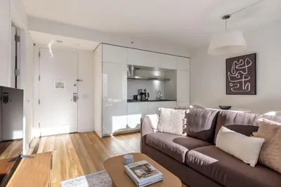a living room with a couch and a table at Midtown West 1br w doorman nr rockefeller center NYC-1394 in New York