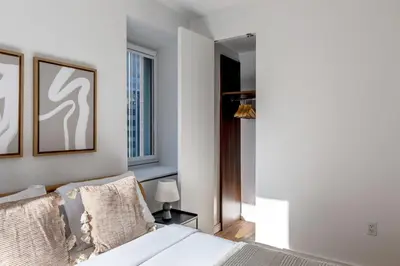 a bedroom with a white bed and a window at Midtown West 1br w doorman nr rockefeller center NYC-1394 in New York
