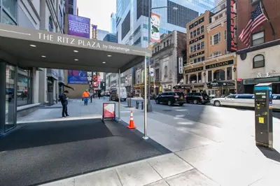a city street with a sign for the ritz pizzeria at Midtown 1br w gym elevator nr Rockefeller Ctr NYC-1401 in New York