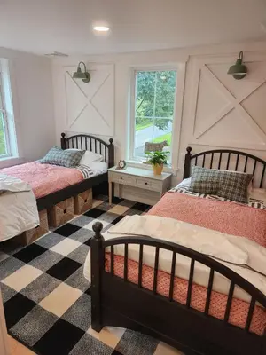a bedroom with two beds and a checkered floor at Pocono Farmhouse - Fully Renovated 1881 Home in Saylorsburg