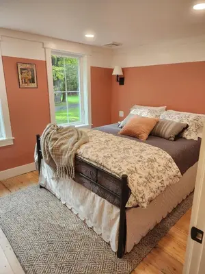 a bedroom with a bed and a window at Pocono Farmhouse - Fully Renovated 1881 Home in Saylorsburg