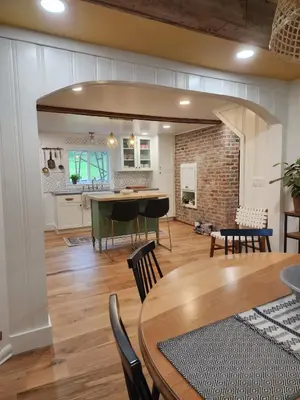 a dining room and kitchen with a table and chairs at Pocono Farmhouse - Fully Renovated 1881 Home in Saylorsburg