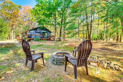 two chairs and a fire pit in front of a house at Peaceful Pocono Gem! Cabin 6 Mi to Dtwn Jim Thorpe in Jim Thorpe