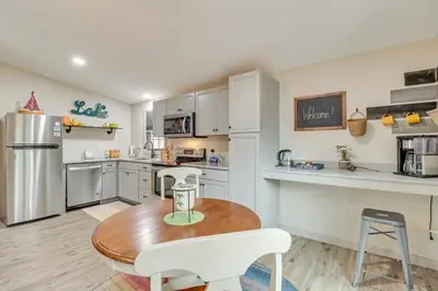 a kitchen with a wooden table and white appliances at Peaceful Pocono Gem! Cabin 6 Mi to Dtwn Jim Thorpe in Jim Thorpe