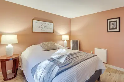 a bedroom with a bed and a picture on the wall at Peaceful Pocono Gem! Cabin 6 Mi to Dtwn Jim Thorpe in Jim Thorpe