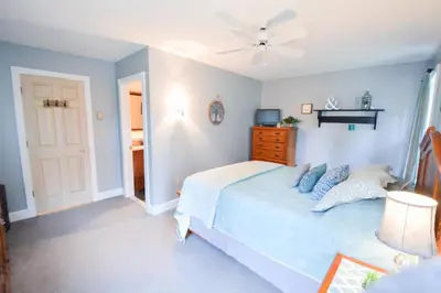 a bedroom with a bed and a ceiling fan at Paper Mill Pines Bed and Breakfast in Shickshinny