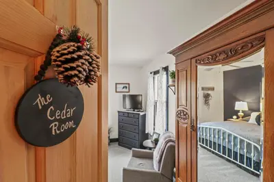 a bedroom with a bed and a sign that reads the center room at Paper Mill Pines Bed and Breakfast in Shickshinny