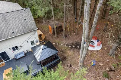 an aerial view of a house in the woods at Creekside Recess Hottub Sauna Firepit Gameroom