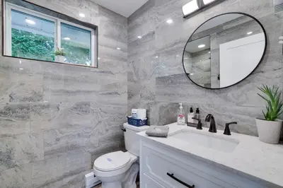 a bathroom with a sink and a mirror at POCONOS BRAND NEW LAKEFRONT Oasis 1 ACRE, HOTTUB GAMEROOM FIREPITS TALK ABOUT PRIVACY in Albrightsville