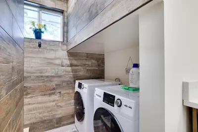 a laundry room with a washer and dryer at POCONOS BRAND NEW LAKEFRONT Oasis 1 ACRE, HOTTUB GAMEROOM FIREPITS TALK ABOUT PRIVACY in Albrightsville