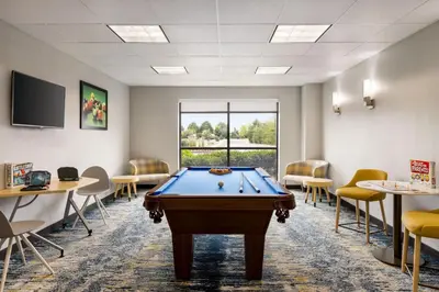 a pool table in a waiting room with chairs at TownePlace Suites by Marriott Harrisburg West/Mechanicsburg in Mechanicsburg