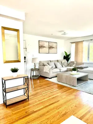 a living room with a couch and a table at Stylish Evergreen Apartment By Newark Airport in Newark