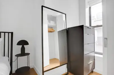 a mirror in a bedroom with a bed and a desk at Little Italy 1br w wd nr SoHo NYC-756 in New York
