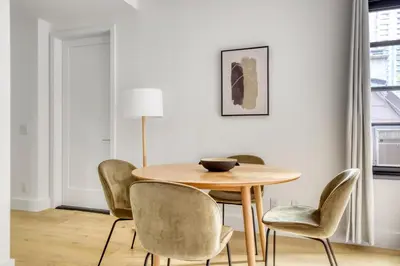 a dining room with a wooden table and chairs at BK Heights 2BR w WD Elevator nr Promenade NYC-910 in Brooklyn