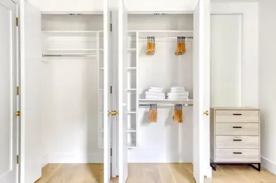 a walk in closet with white walls and white cabinets at BK Heights 2BR w WD Elevator nr Promenade NYC-910 in Brooklyn
