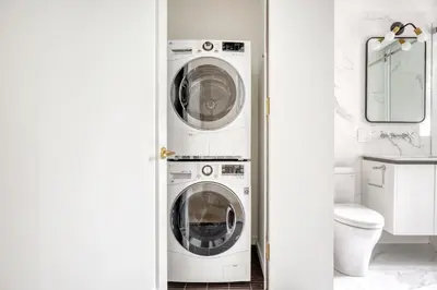 a white laundry room with a washer and dryer at BK Heights 2BR w WD Elevator nr Promenade NYC-910 in Brooklyn
