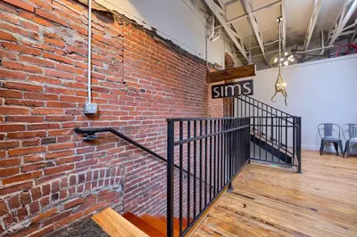 a brick wall with a staircase in a room at Sweet Lancaster Apt. B in Lancaster