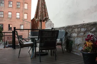 a patio with chairs and a table and an umbrella at Sweet Lancaster Apt. B in Lancaster