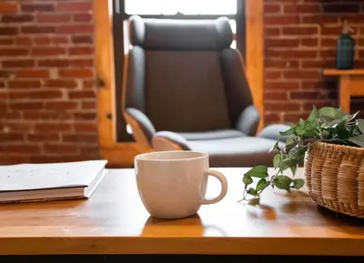 a coffee cup sitting on a table with a chair at Sweet Lancaster Apt. B in Lancaster