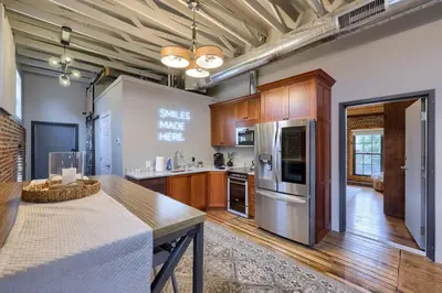 a large kitchen with wooden cabinets and stainless steel appliances at Sweet Lancaster Suite in Lancaster