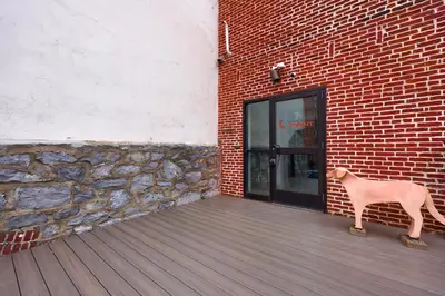 a dog statue standing outside of a brick building at Sweet Lancaster Suite in Lancaster