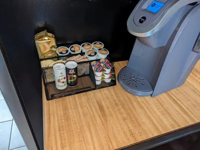 a table with cupcakes and a coffee machine at Poconos Chalet in Tobyhanna