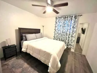 a bedroom with a bed and a ceiling fan at Poconos Chalet in Tobyhanna