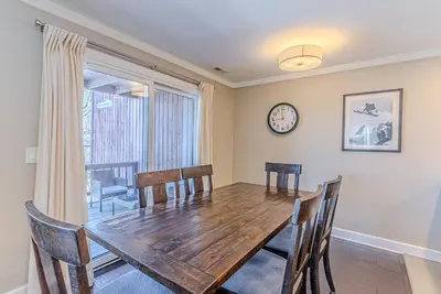 a dining room with a wooden table and chairs at Skylift Lodge - Luxury Mountain Creek family condo in Vernon Township