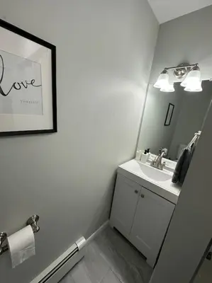 a bathroom with a sink and a mirror at Cozy 2 BR suite, 10 min to NYC &Times Sq in West New York