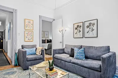 a living room with a couch and a chair at 2BR Apt Walk to Restaurants & Time Square in New York