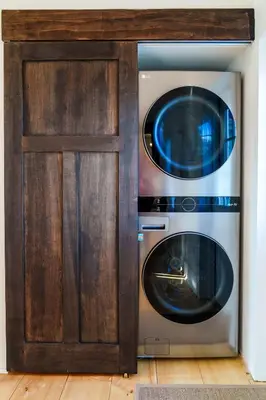 a microwave and a washer and dryer in a cabinet at Very Cozy, 2 Bedroom Farmhouse Apartment 2nd FL in Lancaster