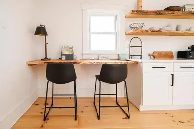 a kitchen with a counter with two stools at it at Very Cozy, 2 Bedroom Farmhouse Apartment 2nd FL in Lancaster