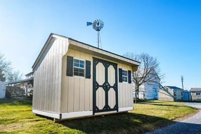 a small shed with a windmill on top of it at Very Cozy, 2 Bedroom Farmhouse Apartment 2nd FL in Lancaster