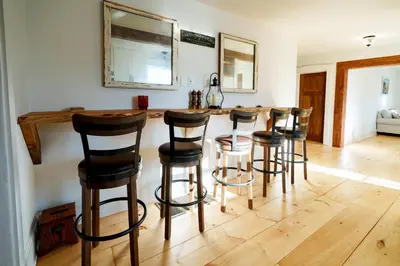 a kitchen with a bar with four stools at Very Comfy Farmhouse Apartment Unit A, 1st FL in Lancaster