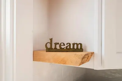 a shelf in a kitchen with a dream sign on it at Very Comfy Farmhouse Apartment Unit A, 1st FL in Lancaster