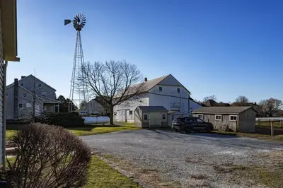 a car parked in front of a house with a windmill at Very Comfy Farmhouse Apartment Unit A, 1st FL in Lancaster
