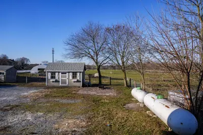 a small house with pipes in front of a field at Very Comfy Farmhouse Apartment Unit A, 1st FL in Lancaster