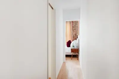 a white room with a bed and a hallway at 153-5A Charming 2BR LES W D in New York