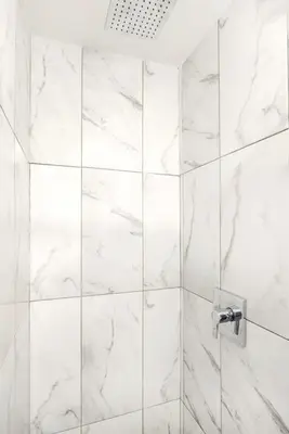 a white marble shower with a glass door at 153-5A Charming 2BR LES W D in New York