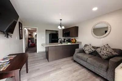 a living room with a couch and a kitchen at Lock Haven Grandview Hotel in Mill Hall