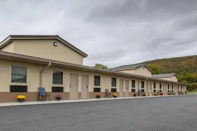 a large building with a road in front of it at Lock Haven Grandview Hotel in Mill Hall
